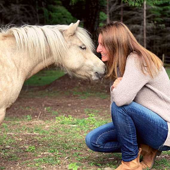 Single white wild mare standing calm.
